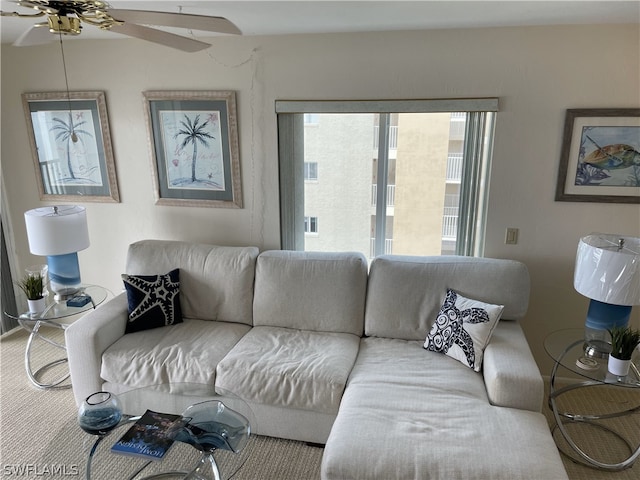 carpeted living room with ceiling fan