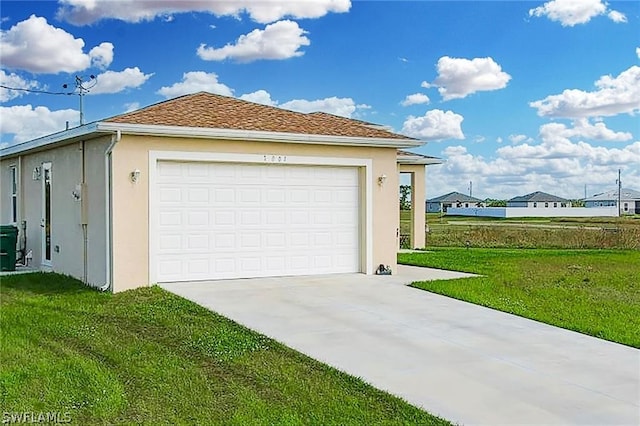 garage featuring a lawn