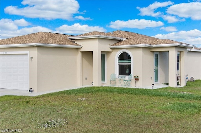 exterior space with a garage and a front lawn