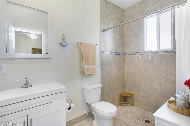 bathroom with ceiling fan, curtained shower, vanity, and toilet