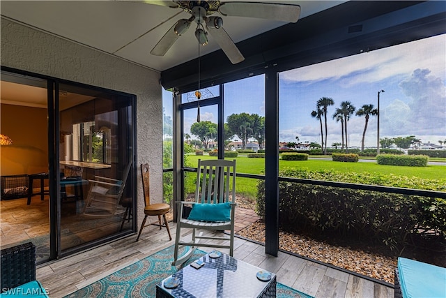 sunroom / solarium featuring ceiling fan