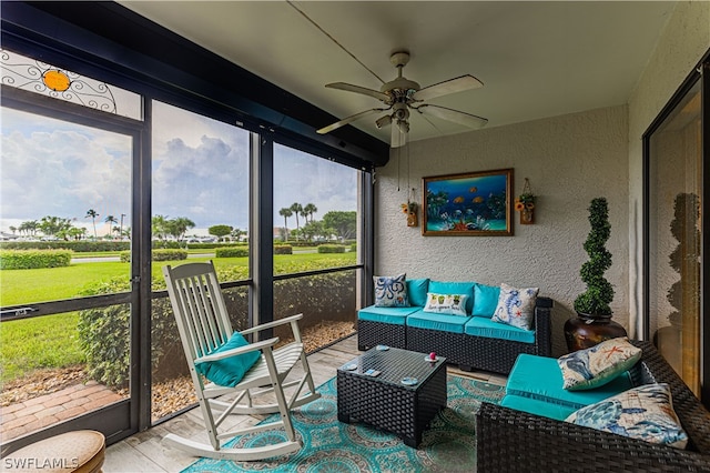 sunroom / solarium featuring ceiling fan