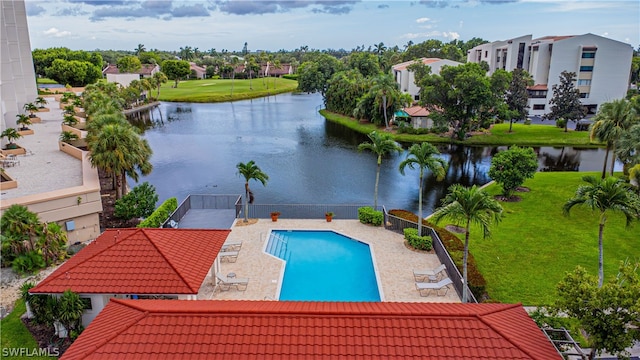 view of swimming pool featuring a water view and a patio area