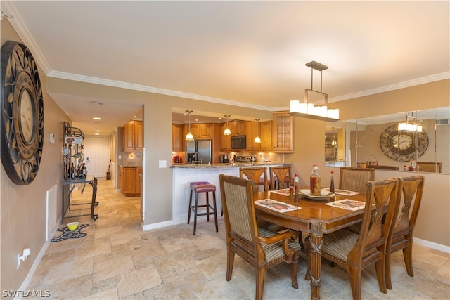 tiled dining room featuring crown molding