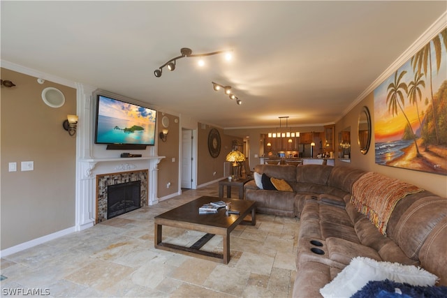 living room with ornamental molding, light tile patterned floors, rail lighting, and a high end fireplace