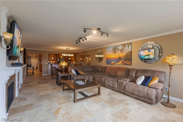 tiled living room featuring ornamental molding and rail lighting