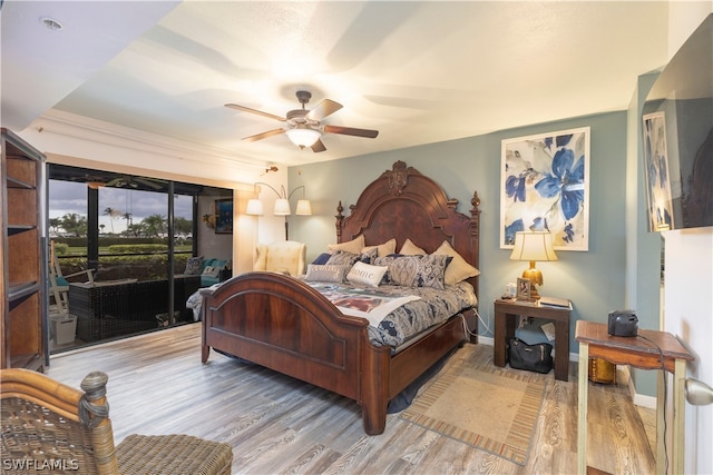 bedroom with access to outside, light hardwood / wood-style flooring, and ceiling fan