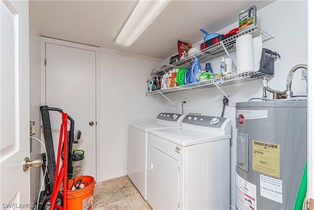 clothes washing area featuring water heater, separate washer and dryer, and light tile patterned floors