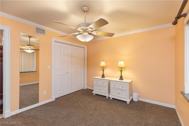 unfurnished bedroom featuring ornamental molding, ceiling fan, dark carpet, and a closet