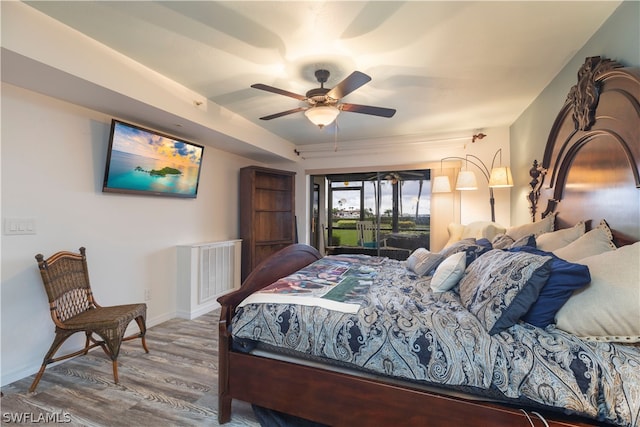 bedroom with access to outside, hardwood / wood-style floors, and ceiling fan