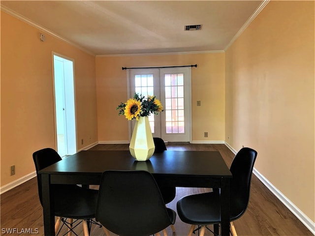 dining area featuring ornamental molding, french doors, and dark hardwood / wood-style floors