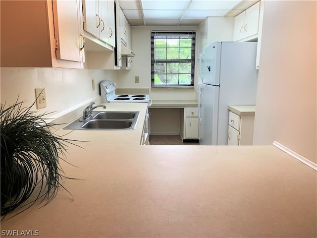 kitchen with white appliances, sink, and a paneled ceiling