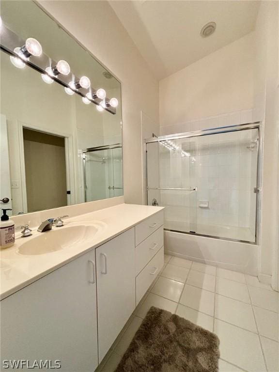 bathroom with tile patterned flooring, vanity, and shower / bath combination with glass door