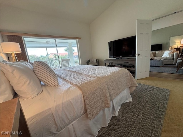 bedroom with access to exterior, vaulted ceiling, and carpet