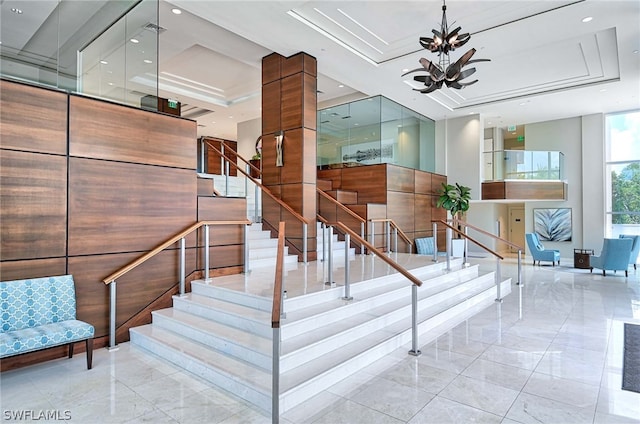 stairs with an inviting chandelier