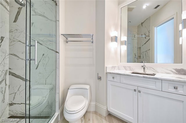 bathroom featuring vanity, hardwood / wood-style flooring, toilet, and walk in shower