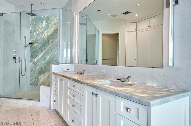 bathroom featuring vanity, tile patterned floors, and a shower with shower door