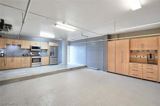 interior space featuring light brown cabinets, stainless steel appliances, and sink