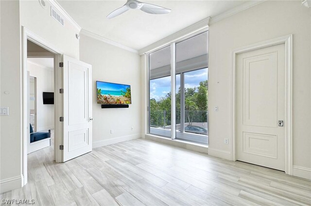 empty room featuring light hardwood / wood-style floors, ceiling fan, and ornamental molding