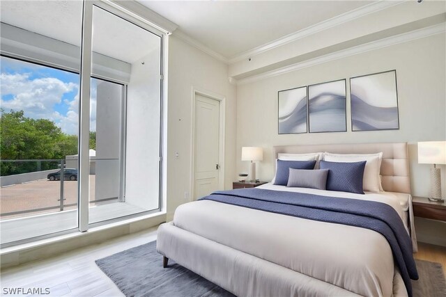 bedroom with access to exterior, crown molding, and wood-type flooring