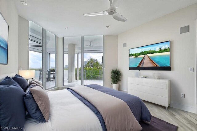 bedroom featuring ceiling fan, access to exterior, light wood-type flooring, and multiple windows