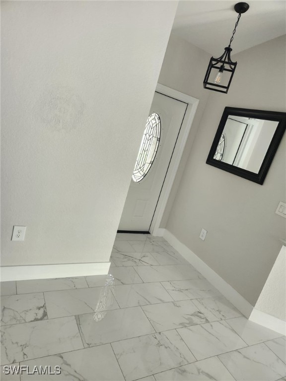 entryway featuring a chandelier