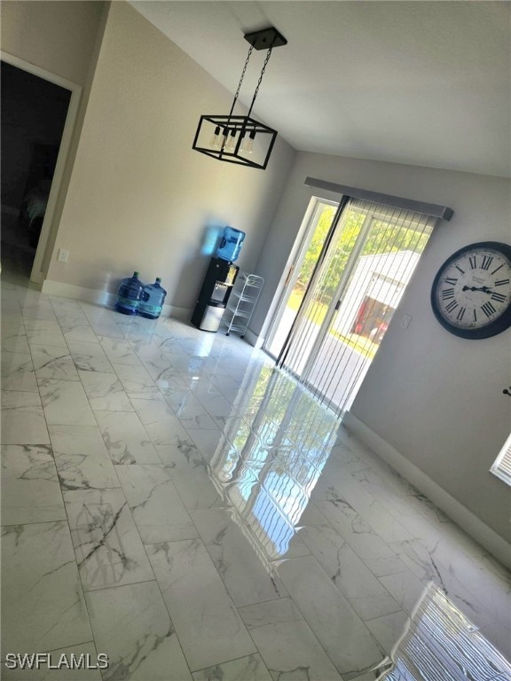 foyer with lofted ceiling and a notable chandelier