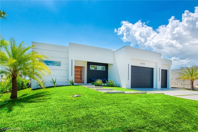 contemporary house with a garage and a front yard