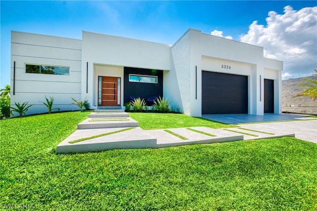 modern home featuring a garage and a front yard