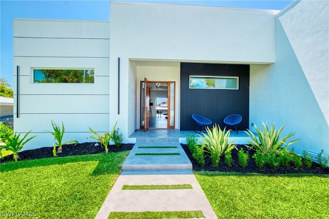 entrance to property featuring a yard