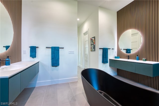 bathroom with a bath, tile floors, and large vanity