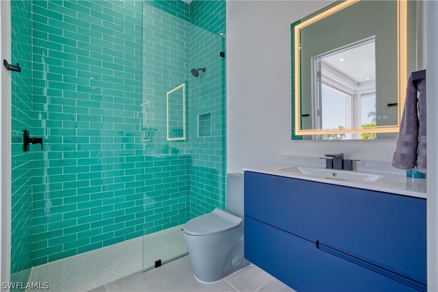 bathroom featuring tile flooring, tiled shower, toilet, and vanity