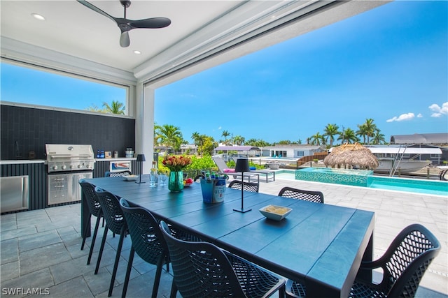 view of patio featuring exterior kitchen and ceiling fan