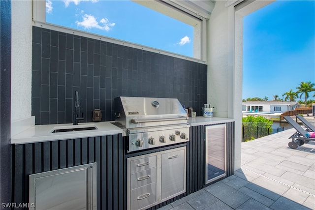 view of patio / terrace with area for grilling, sink, and an outdoor kitchen