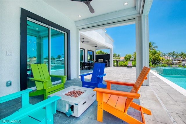 view of patio / terrace with ceiling fan and a fire pit