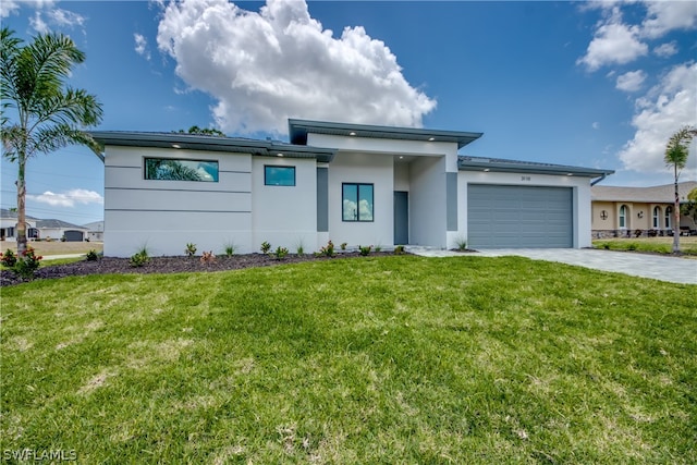 view of front of home with a garage and a front lawn