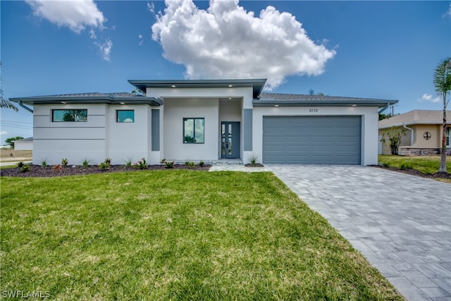 view of front of home with a garage and a front yard