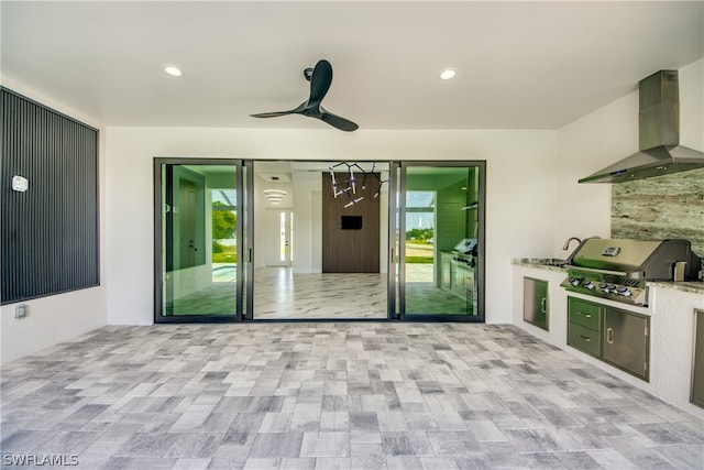 interior space featuring ceiling fan, area for grilling, and exterior kitchen