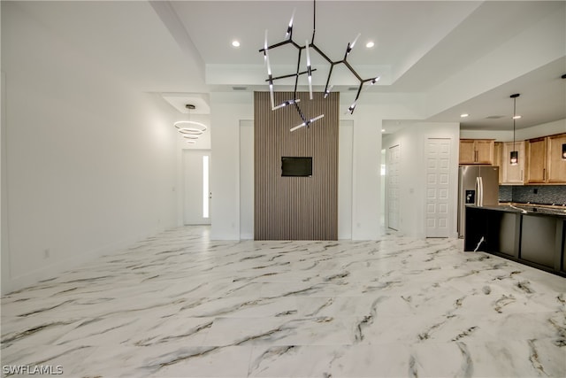 kitchen featuring hanging light fixtures, backsplash, stainless steel refrigerator with ice dispenser, light tile patterned flooring, and a notable chandelier