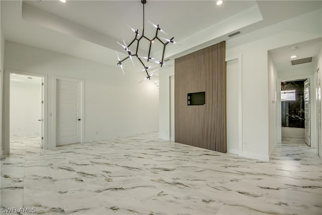 unfurnished dining area featuring light tile patterned floors and a raised ceiling