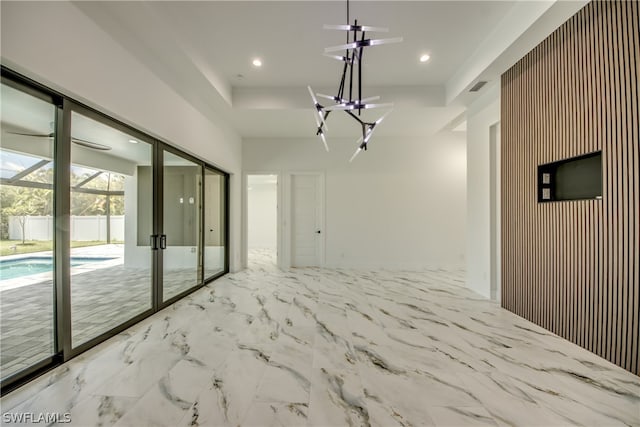 unfurnished room featuring ceiling fan with notable chandelier and light tile patterned floors