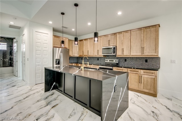 kitchen featuring light tile patterned flooring, a kitchen island with sink, and stainless steel appliances