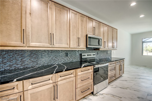 kitchen with light brown cabinetry, dark stone countertops, light tile patterned floors, and stainless steel appliances