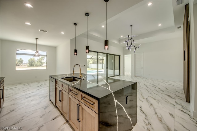 kitchen featuring light tile patterned flooring, stainless steel dishwasher, an island with sink, decorative light fixtures, and sink