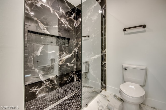 bathroom with tile patterned floors, toilet, and a tile shower