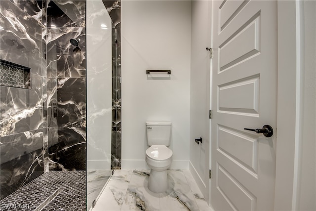 bathroom with toilet, tile patterned floors, and a tile shower