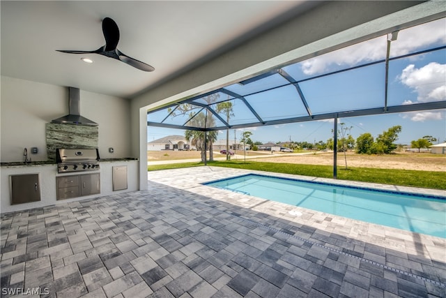 view of pool featuring exterior kitchen, a patio area, ceiling fan, sink, and area for grilling