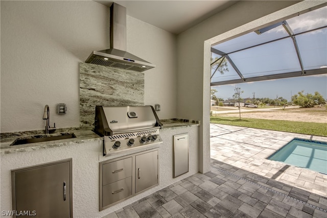 view of patio / terrace featuring glass enclosure, area for grilling, and sink