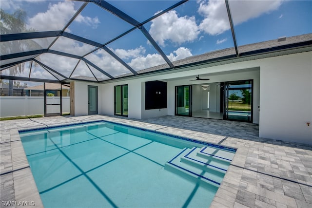 view of pool featuring a patio area, ceiling fan, and glass enclosure