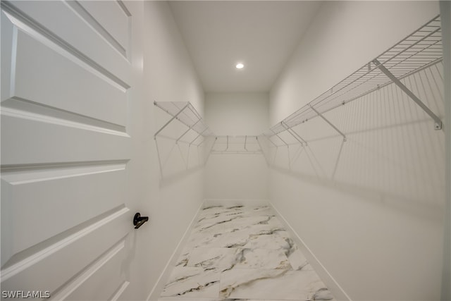 spacious closet with light tile patterned flooring